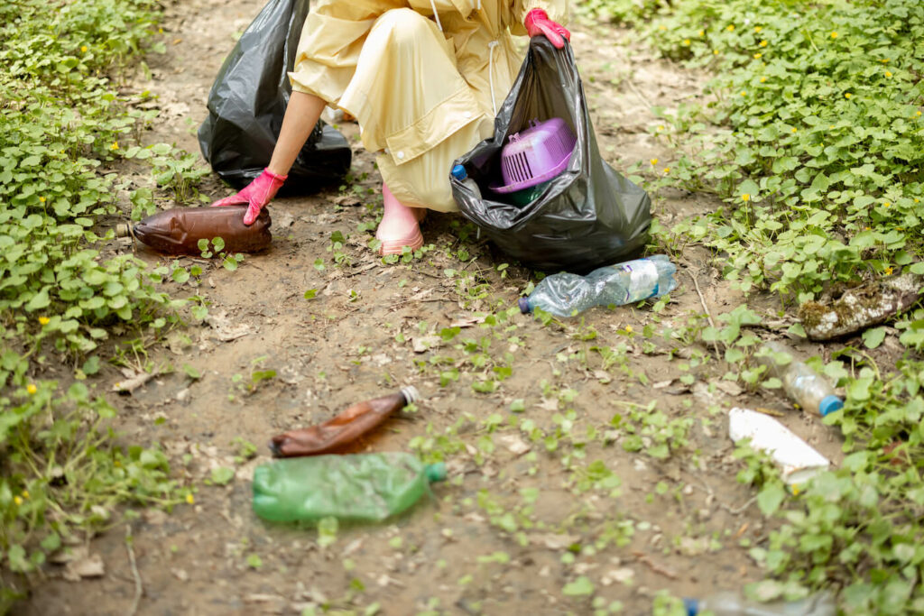 Woman collecting litter bottles